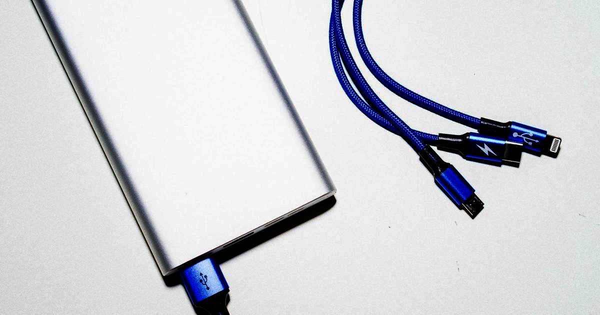 A silver slab power bank with a blue three-headed charging cable