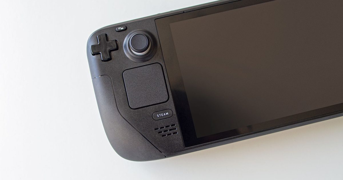 Steam Deck handheld resting on a white surface with its screen off
