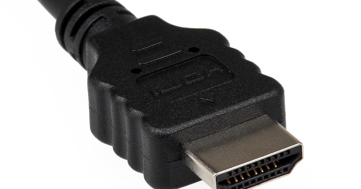 close-up of a black hdmi cable connector with gold pins on white